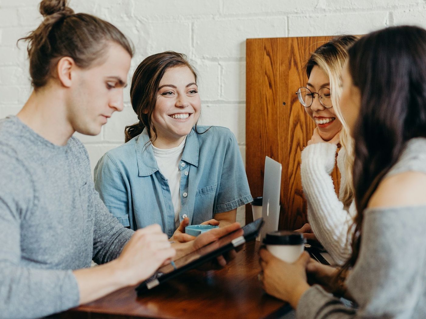 A group of friends laughing at a café table