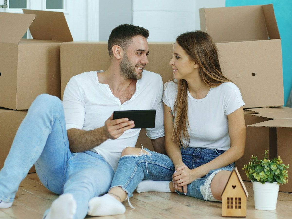 A couple in their new home among moving boxes